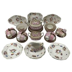 Early to mid 19th century tea service, gilt and relief decorated with floral sprigs against a pink banded ground, comprising teapot, two slop bowls, sucrier, milk jug, thirteen teacups, fourteen saucers etc, together with a 19th century nine piece dessert service, painted in bright enamels with floral sprays 