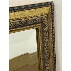  Gilt framed overmantel mirror with arched top (114cm x 81cm) and an upright gilt framed wall mirror with bevelled plate (46cm x 100cm)  