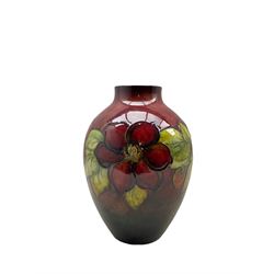 Walter Moorcroft Clematis pattern flambé vase on a deep red ground, H27cm