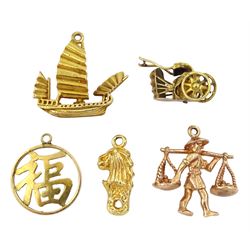 Two 14ct gold charms including rickshaw and lion and three 9ct gold charms including Chinese farmer