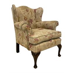 Late 20th century beech framed armchair, upholstered in floral pattern fabric with sprung seat, on cabriole front supports