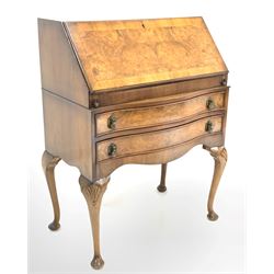 Early 20th century Queen Anne style figured walnut bureau, the cross banded fall front revealing interior fitted with drawer, correspondence shelves and an inset writing surface, over two bowfront drawers and shaped apron, raised on shell carved cabriole supports W77cm, H100cm, D46cm