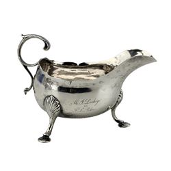 18th century Irish silver cream jug with crimped rim and C scroll leaf capped handle and hoof feet with presentation inscription Dublin assay Maker George Hill
