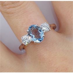 18ct white gold three stone oval aquamarine and round brilliant cut diamond ring, hallmarked, aquamarine approx 0.90 carat, total diamond weight approx 0.45 carat