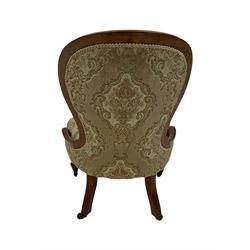 Victorian nursing chair, the mahogany show frame with floral upholstery, raised on ceramic castors  
