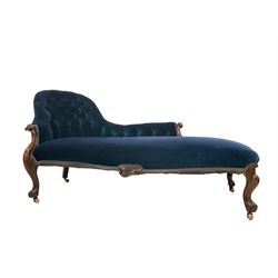 Late 19th century rosewood framed chaise longue, the buttoned back and sprung serpentine seat upholstered in royal blue velvet fabric, the arm terminals carved and scrolled and the apron with central foliate motif, raised on cabriole supports terminating in ceramic castors
