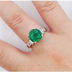18ct white gold three stone round emerald, baguette and tapered baguette cut diamond ring, hallmarked, emerald approx 3.10 carat