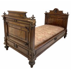 Late 19th century French Empire design mahogany single bed, the head board centred by a carved mask over geometric panels, raised on turned supports with a box base, W98cm, L190cm
