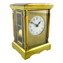 French - late19th century spring driven 8-day table clock, with four bevelled glass panels, brass case with a convex top and shaped stepped base, gilt dial mask and circular white enamel dial with upright Arabic’s and minute markers,  non-matching fleur de Lis hands, eight-day spring driven movement with rack striking, sounding the hours and half-hours on a coiled gong, with a jewelled lever platform escapement, balance with regulation and timing screws, original baseplate cover, movement backplate stamped “Made in France” with key