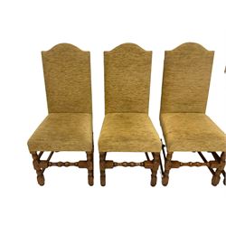 Set eight oak framed dining chairs, high arched back and seat upholstered in light ochre fabric, on turned supports joined by turned front stretcher, with visible peg joints