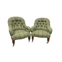 Pair late 19th century walnut framed armchairs, upholstered in deep buttoned green tartan fabric with sprung seat, the apron lined with studwork, raised on heavily turned supports with brass cups and castors