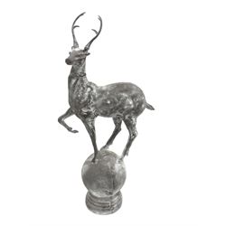Pair of cast metal garden figures or gate post finials in the form of stags on spherical mounts
