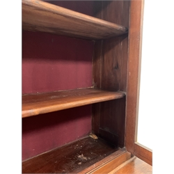 Early to mid 19th century walnut bookcase on chest, projecting cornice over two glazed doors enclosing two shelves, two short and three long graduated drawers under, raised on turned supports 