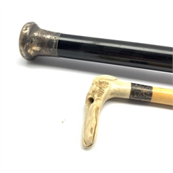 Walking stick with carved horn dogs head handle and an ebonised evening cane with silver top 