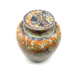 Chinese red ground ginger jar and cover, decorated in underglaze blue with a mountanious landscape and lake scene, amongst polychrome painted foliage, Geometric bands and Dragon, H23cm  
