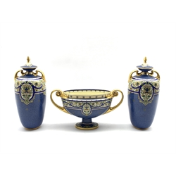 Royal Worcester garniture comprising pair of two handled vases and covers painted with panels of flowers on a mottled blue ground with gilt handles and lifts H26cm and a matching oval pedestal two handled vase W28cm, date code 1920