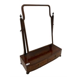 19th century figured walnut swing toilet mirror, the rectangular bevelled plate supported by reeded uprights, the bowfront base fitted with two burr walnut fronted drawers, raised on bun feet with carved gadroon detail