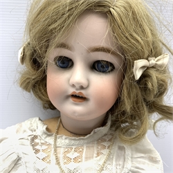 Simon & Halbig bisque head doll with blue glass sleeping eyes, open mouth and teeth, pierced ears, blonde mohair wig, jointed composition limbs and body, marked 10 1/2  H65cm 