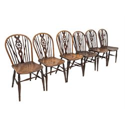 Early 19th century harlequin set of six elm and beech Windsor chairs, hoop and stick back with pierced wheel splat, on dished saddle seats, turned supports joined by swell turned stretchers, two stamped on rear 