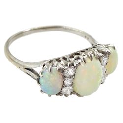 Early 20th century 18ct white gold three stone opal and six stone old cut diamond ring, in velvet and silk lined leather box 