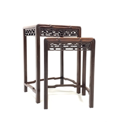 Nest of two Chinese hardwood occasional tables, with figured top over pierced carved frieze, moulded supports united by stretchers, W42cm D30cm H60cm (max)