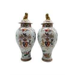 Pair of 19th century Samson of Paris armorial vases and covers decorated in the Chinese manner with Dog of Fo lifts, coat of arms and flowers etc H40cm 