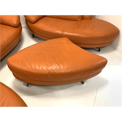 Contemporary Italian lounge suite, comprised of an orange leather two seat sofa, raised on brushed metal supports, (W228cm) with a matching chaise longue and two shaped footstools, retailed by Bohm of Manchester