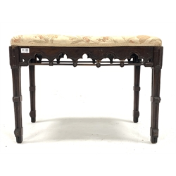 Victorian mahogany duet stool of Gothic design, with upholstered seat over arch carved apron, raised on carved square tapered supports, W74cm, H53cm, D46cm