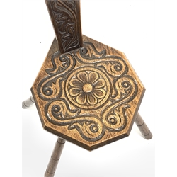 20th century oak spinning chair, relief carved with flower head, s scrolls and leafage, pierced heart shaped handle, four outsplayed supports, H93cm