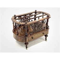 Victorian figured walnut Canterbury magazine rack, with two divisions raised on turned spindle gallery, pierce carved fretwork over one drawer with boxwood string inlay, raised on turned supports and brass and ceramic castors, W69cm