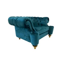 Chesterfield style armchair, scrolled arms and uprights, upholstered in buttoned teal velvet, on turned tapering brass finish feet