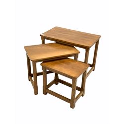 Robert 'Mouseman' Thompson of Kilburn - Yorkshire oak nest of three tables, each with an adzed rectangular top raised on octagonal carved supports bearing mouse signature 61cm x 38cm, H48cm