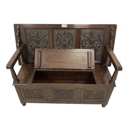 18th century design oak monks bench, the metamorphic top carved with three faux panels depicting scrolling foliate and seahorse motifs, over box seat with hinged lid, the front panels carved with foliate lunettes