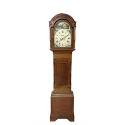 8-day - mid 19th century mahogany longcase, with a round top and carved frieze beneath, glazed break arch door flanked by two ring turned pilasters, trunk with recessed pilasters and a short flat topped door, on a rectangular plinth with a shaped skirting, painted dial with roman numerals, juxtaposed images of cottages to the spandrels and a depiction of a rural scene to the break arch, with a seconds dial, date aperture and stamped brass hands, with weights and pendulum.