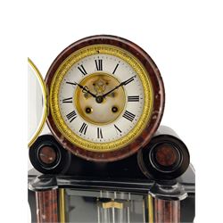 Mougin of Paris – late 19th century 8-day Belgium slate mantle clock with a pair of conforming tazas, waisted case with glazed front panel and visible twin file mercury pendulum, projecting semi-circular rouge and white flecked marble columns on a broad rectangular plinth, two-part enamel dial with a glazed cast brass bezel, visible Brocot dead beat escapement with jewelled cornelian pallets, Roman numerals and steel fleur di Lis hands, count wheel striking movement striking the hours and half hours on a bell. Tazzas H27cm.