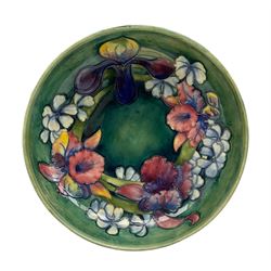 Walter Moorcroft Orchid pattern bowl on a green wash ground, impressed and painted marks beneath, D27cm 