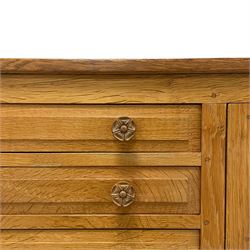 Beaverman - oak sideboard, rectangular adzed top over five graduating drawers flanked by panelled cupboards, fitted with Yorkshire Rose carved handles, panelled sides, carved with beaver signature, by Colin Almack, Sutton-under-Whitestone Cliffe, Thirsk