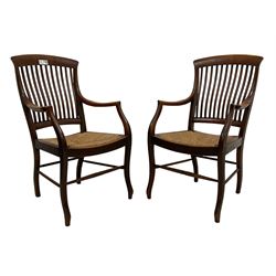Set of six (4+2) early 20th century oak country dining chairs, slat back over drop-in rush seats, raised on cabriole supports united by ring-turned stretchers