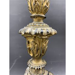 Pair ebonised and gilt pricket table candlesticks, with flared sconce with leaf frieze, baluster pillar, trefoil base with three acanthus capped feet H59cm