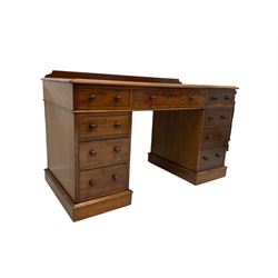 Maple & Co - Edwardian mahogany twin pedestal desk, rectangular top with raised back, fitted with central frieze drawer flanked by four graduating drawers, on castors