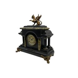 Late 19th century New Haven American mantle clock in a wooden simulated slate and marble case, pediment with a flat top surmounted by a gilded mythical griffin, with four supporting pillars on a deep plinth raised on ornate and gilded bracket feet, dial with Arabic numerals, gothic steel hands and pendulum regulation, eight-day movement striking the hours and half hours on a coiled gong.  With pendulum.
