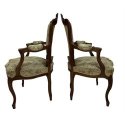 Pair of Victorian armchairs, the walnut show frame with floral upholstery, raised on cabriole supports  