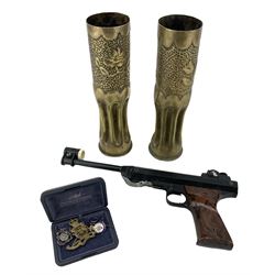 Italian RO71 .177 air pistol, a pair of trench art vases, and a small collection of cap badges