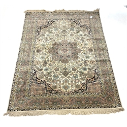 Persian design silk ground rug, central medallion on busy ivory field with blue spandrels, enclosed by double guarded border