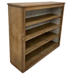 Victorian pine open bookcase, the rectangular top with moulded edge over three fixed drawers, raised on a plinth base  