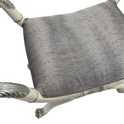 Regency design ivory and silver painted stool, the scrolled side rests moulded with silvered acanthus leaves, seat upholstered in a silver and black snake skin patterned fabric, raised on a curved X-frame base with paw feet