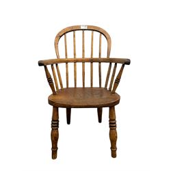 Childs Windsor armchair, the double hooped and spindle back over elm seat, raised on turned supports  