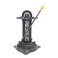  Victorian cast iron stick stand, decorated with mask and scrolled interlaced foliage, (W42cm) and two walking sticks,   