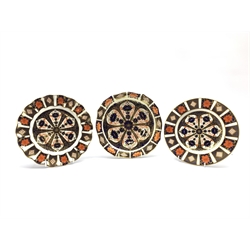 Three Royal Crown Derby Imari pattern plates no. 1128 comprising a wavy edge plate D22cm, a shaped plate dated 1917 and one other (3)
