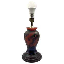 Okra 'Firedance' studio glass table lamp, the inverted baluster form body decorated with iridescent figures dancing, on circular turned wooden base, H20cm excluding brass fitting